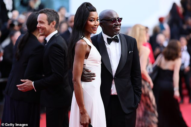 The supermodel styled her raven tresses in a half-up half-down style as she posed alongside fashion editor Edward Enninful