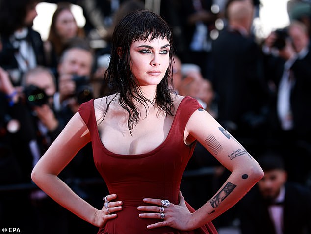 She showed off her intricate tattoos in her statement ensemble as she posed up a storm