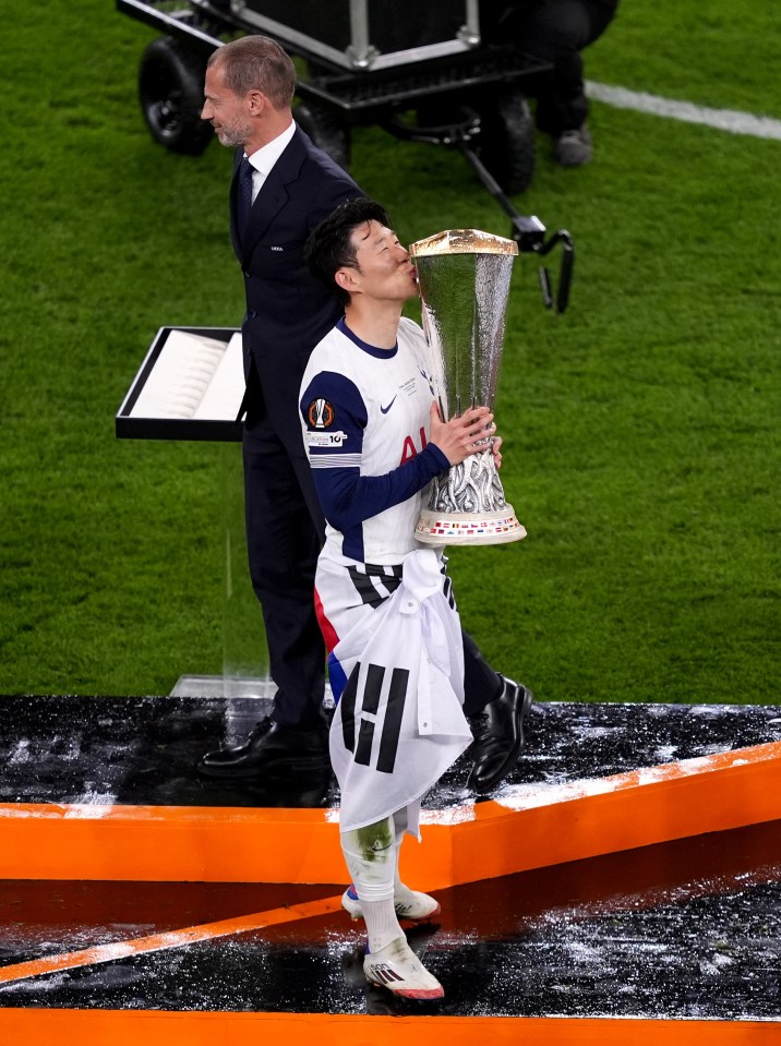 Son Heung-Min of Tottenham Hotspur kissing the UEFA Europa League trophy.