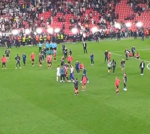 Soccer players on the field after a game.
