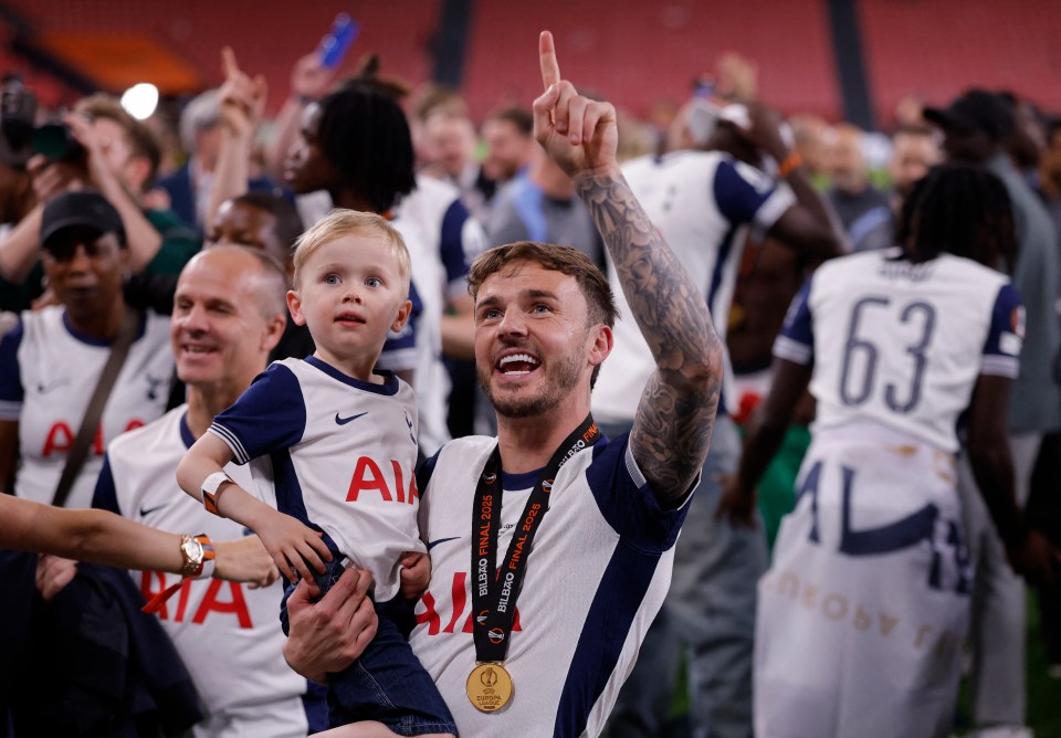 James Maddison of Tottenham Hotspur celebrates winning the Europa League with his son.