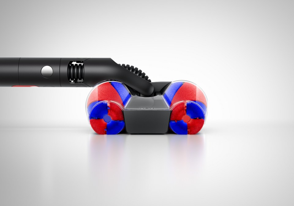 Vacuum cleaner brushroll with red and blue bristles.