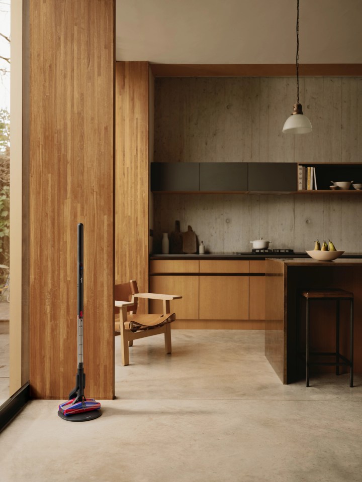A Dyson floor cleaner in a modern kitchen.
