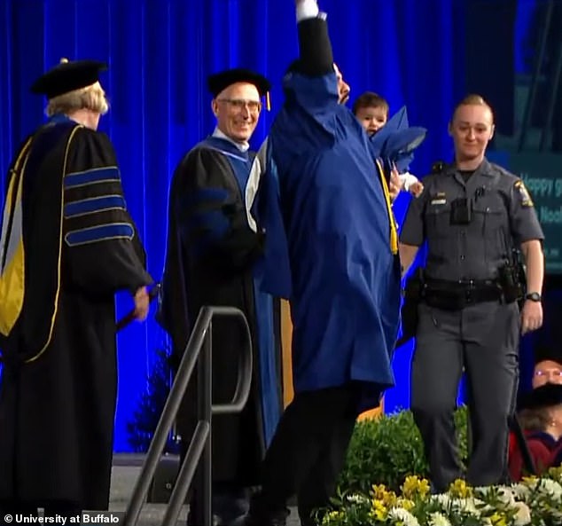 Despite the chaos it took to finally reach the spotlight, the crowd erupted in applause as Al Arab joyfully fist-bumped the air after receiving his diploma