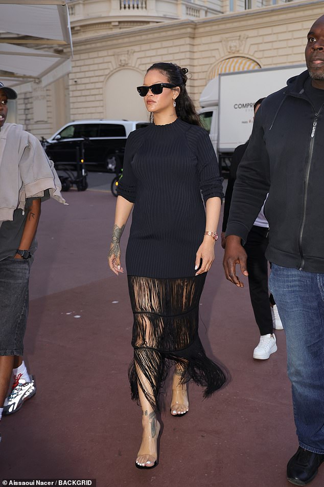 She added a few extra inches to her frame in a pair of clear heels and shielded her eyes with a pair of square shades