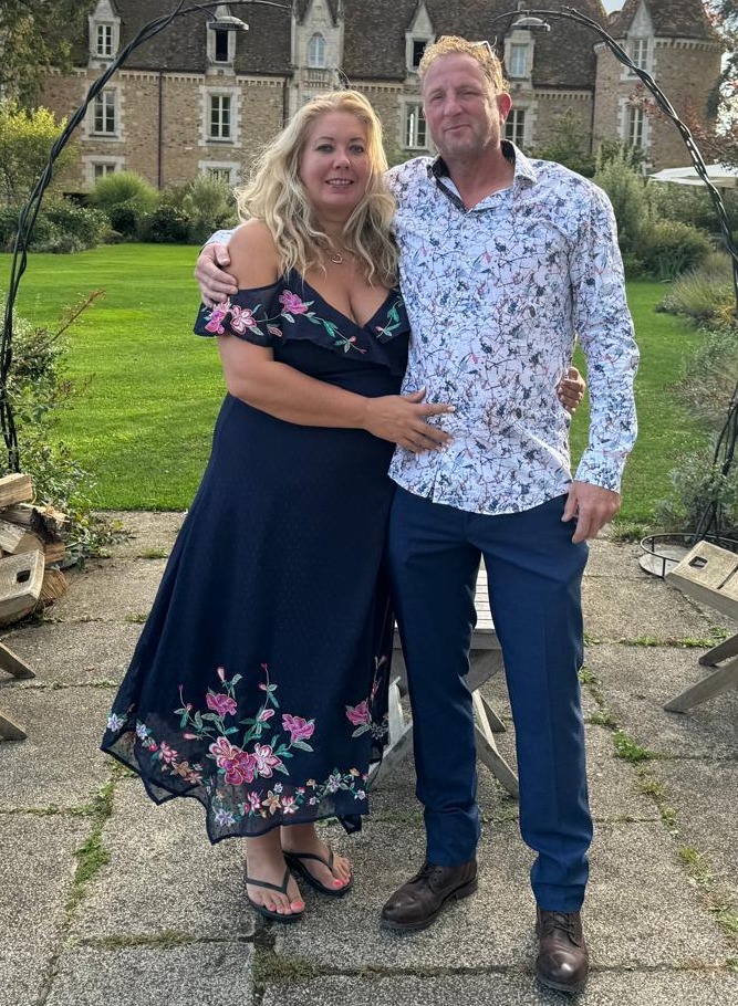 Couple posing in front of a chateau.