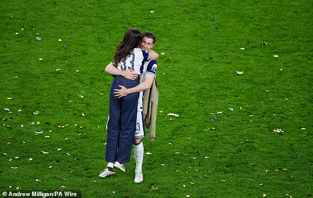 Davies hugged his wife Emily after securing his first winners medal with the club