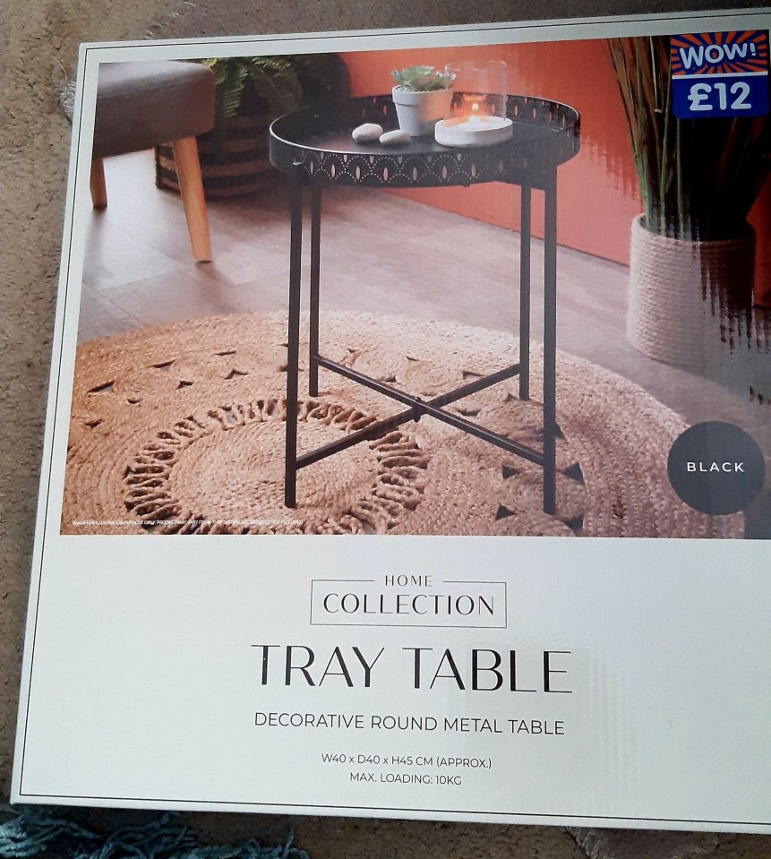 Box showing a black metal tray table.