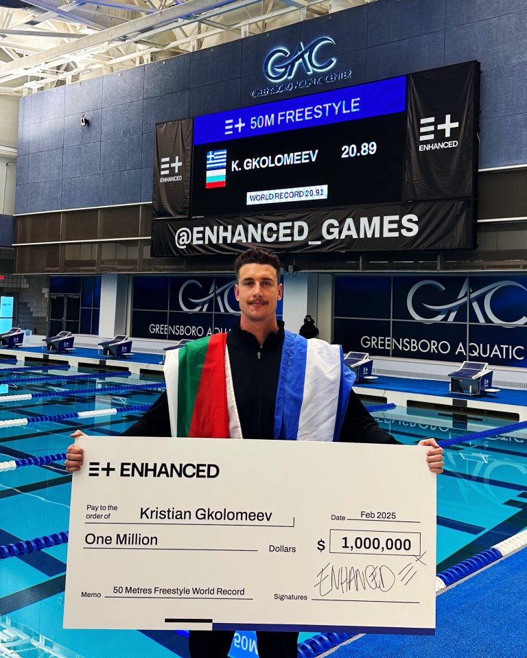 Kristian Gkolomeev holding a $1,000,000 check for breaking the 50m freestyle world record.