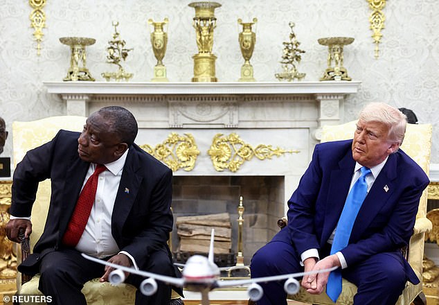 Ramaphosa and Trump are pictured looking towards a monitor that shows videos Trump claimed show evidence of the genocide of white people in South Africa