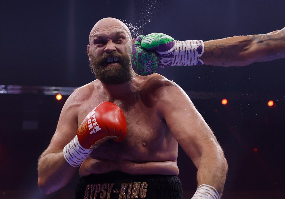 Photo of Tyson Fury being punched during a boxing match.