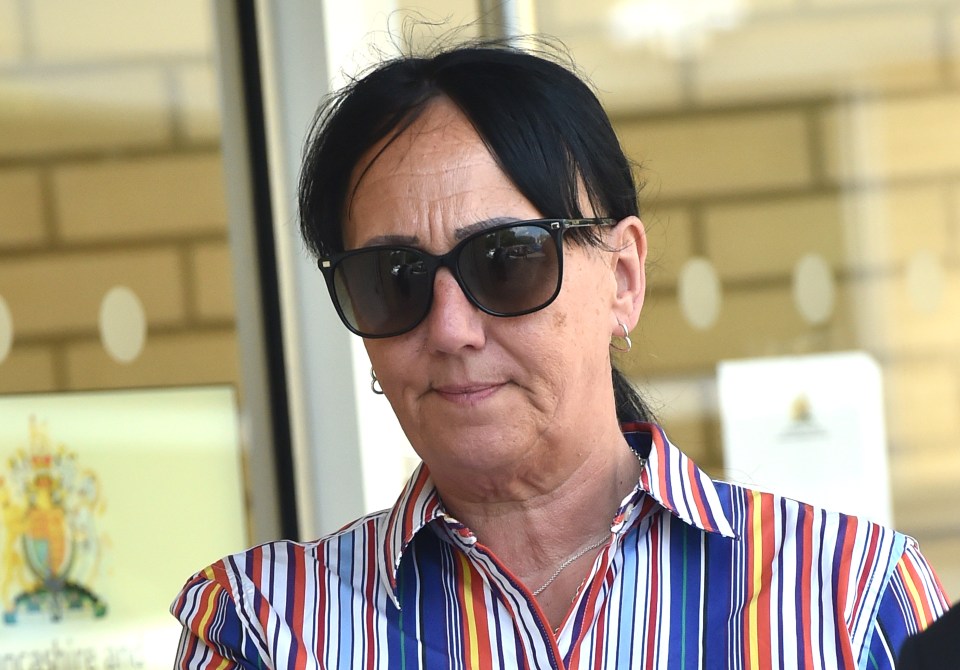Woman wearing sunglasses and striped shirt.