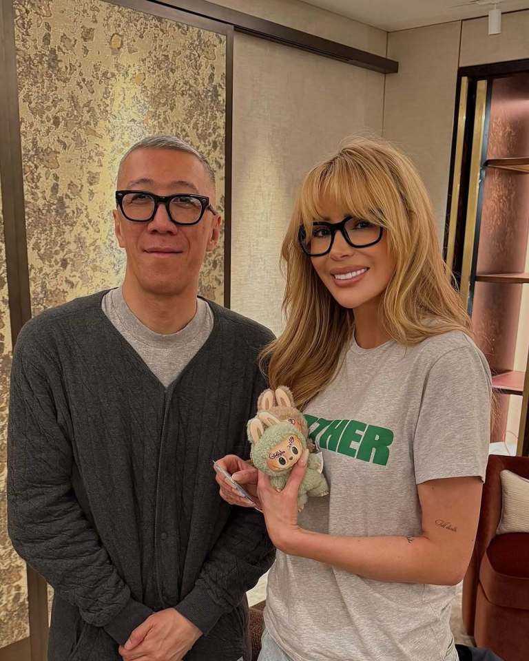 Photo of a man and woman holding a small stuffed animal.