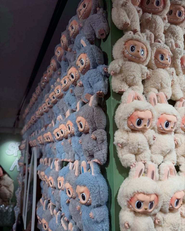 Wall of Labubu dolls.