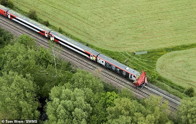 Aerial photographs show how the trailer was struck by the train and dragged along the tracks