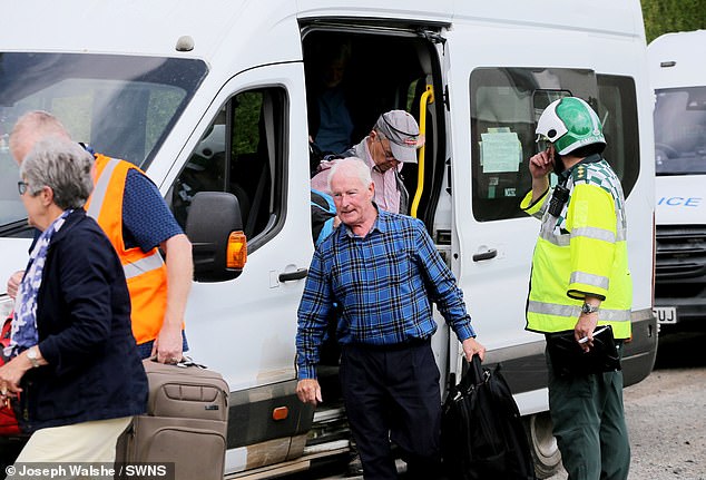 Passengers from the train are taken to a coach to complete their journey