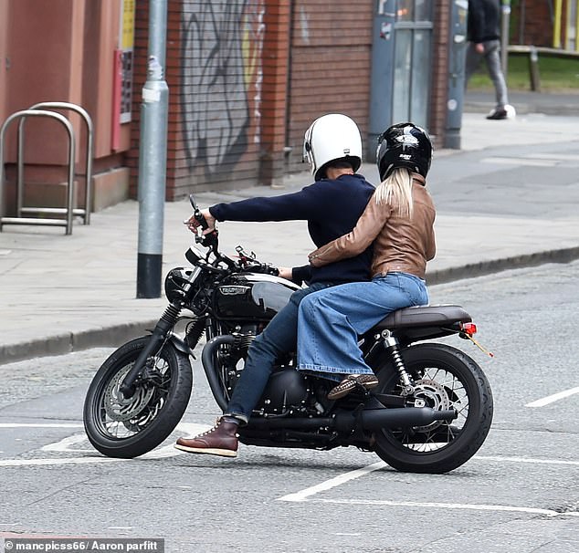 Wearing a black motorbike helmet, the star hopped on the back while Gethin's face could be seen through the visor of his white headgear