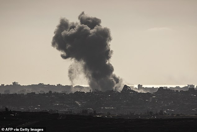Smoke billows above buildings in the northern Gaza Strip on May 19, 2025
