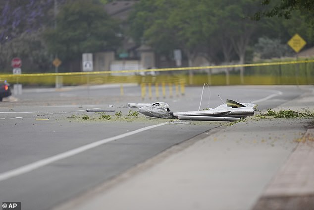Debris covers the ground after a small plane crashed into a San Diego neighborhood