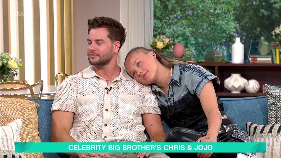 Chris Hughes and JoJo Siwa on a sofa.