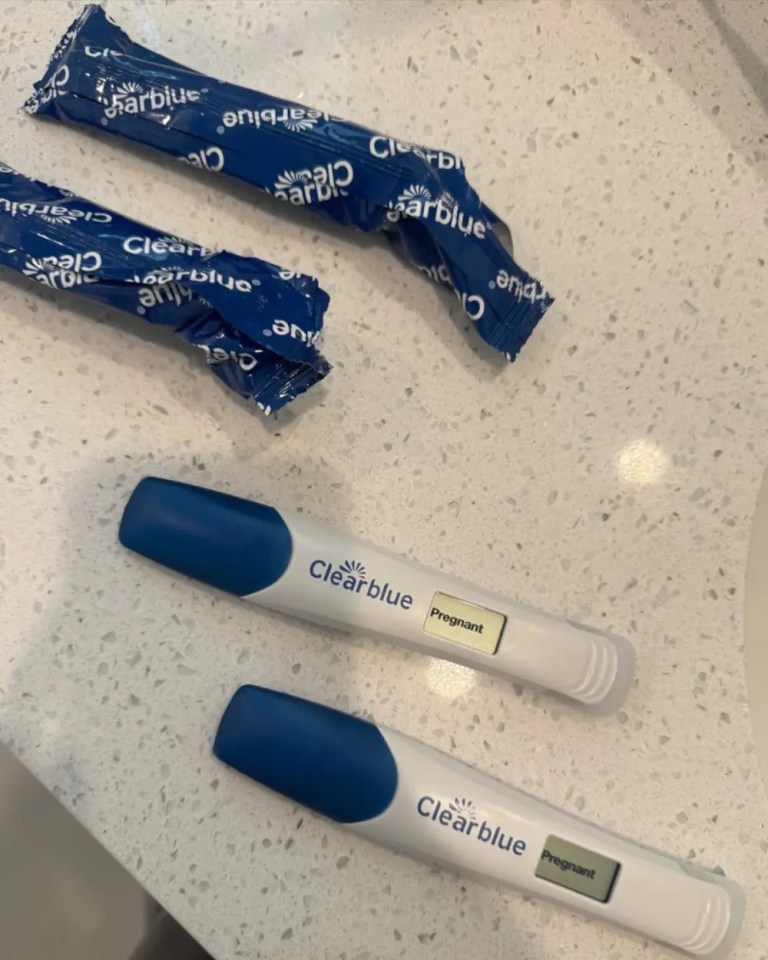 Two positive Clearblue pregnancy tests.