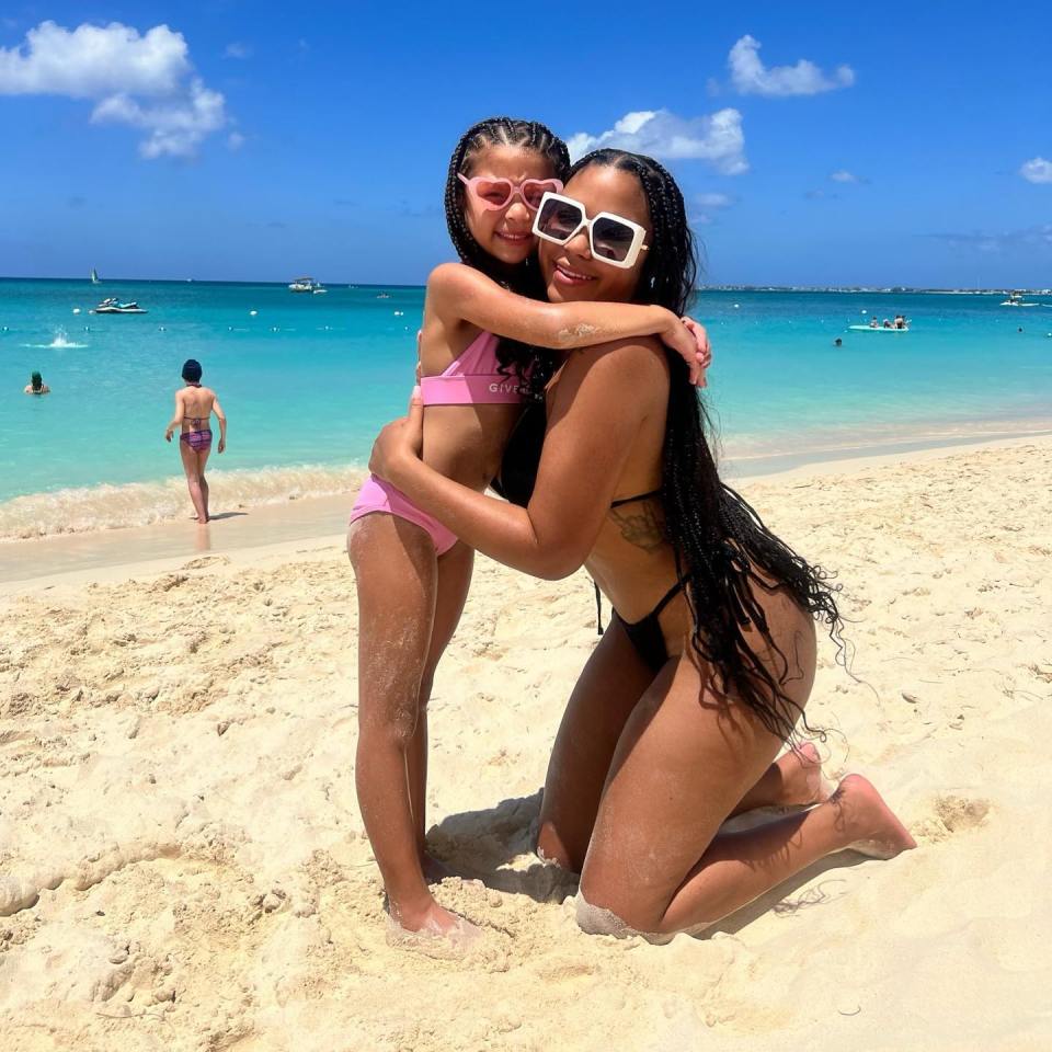 Cheyenne Floyd and her daughter on a beach.