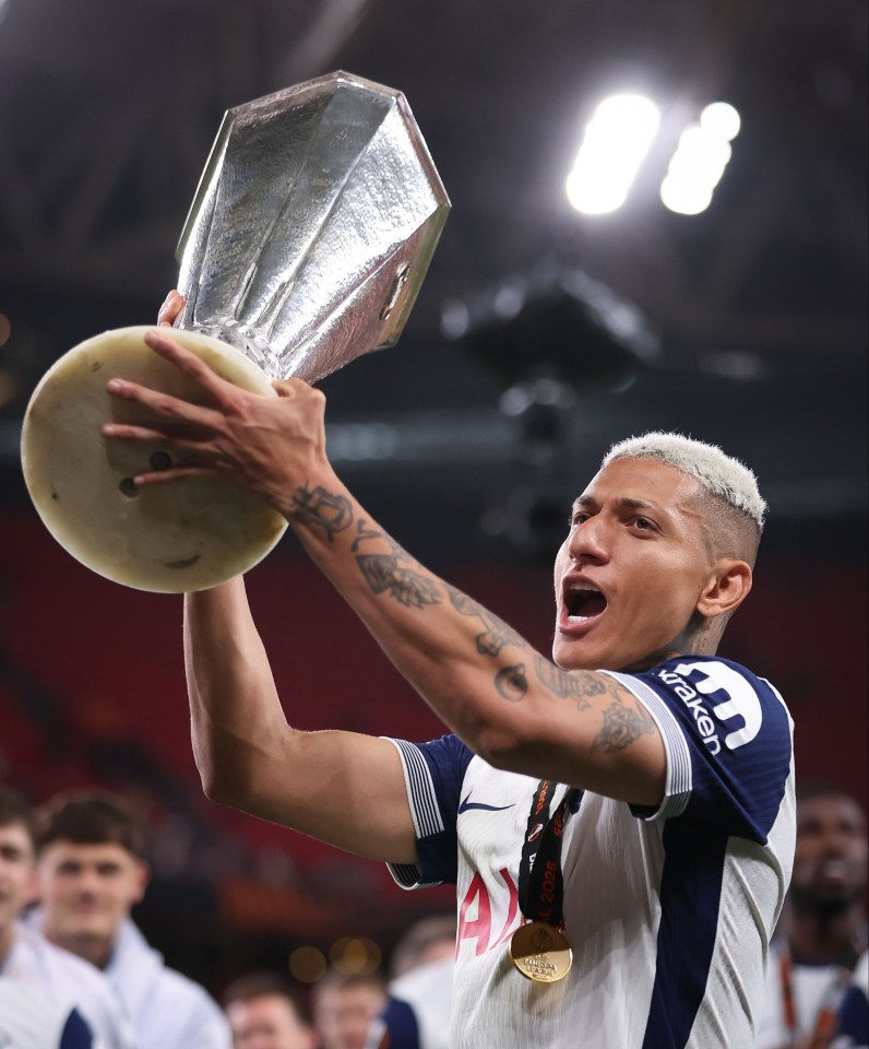 Richarlison of Tottenham Hotspur celebrates a victory, holding the UEFA Europa League trophy.