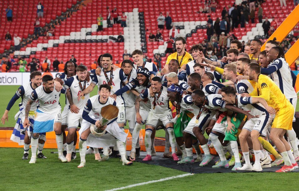 Tottenham Hotspur players celebrating with the UEFA Europa League trophy.