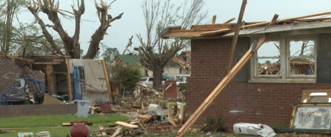 Damaged house after a tornado; couple hospitalized.