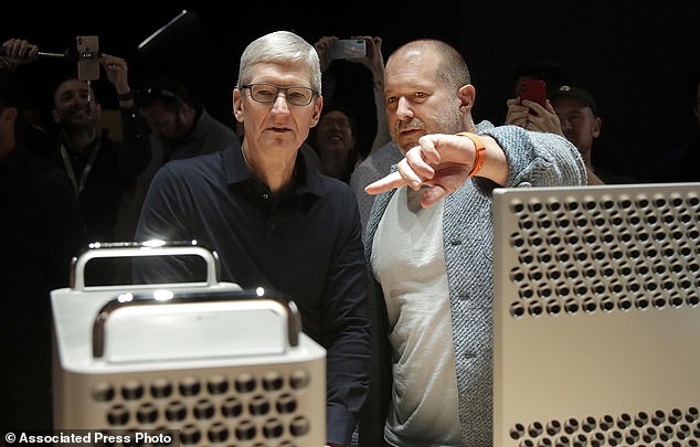 In this Monday, June 3, 2019 file photo, Apple CEO Tim Cook, left, and chief design officer Jonathan Ive look at the Mac Pro in the display room at the Apple Worldwide Developers Conference in San Jose, Calif.