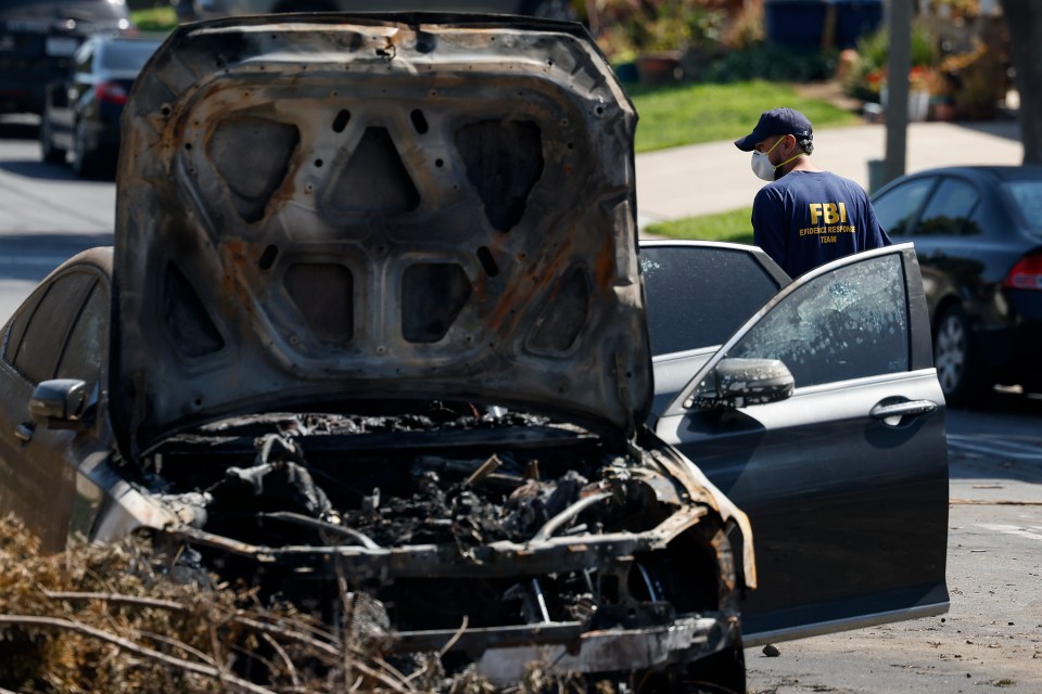 A burned-out car at an airplane crash site with an FBI agent investigating.