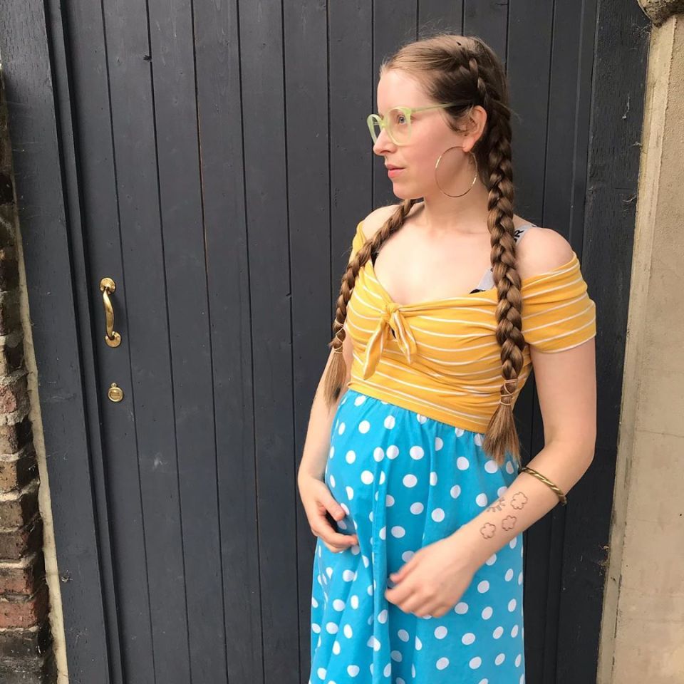 Jessie Cave, pregnant, wearing a yellow and blue polka dot dress.