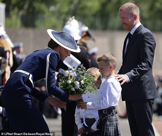 The Princess is presented flowers upon her arrival at the HMS Glasgow naming ceremony