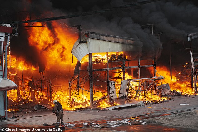 Firefighters extinguish a blaze at the Barabashovo market after a Russian drone strike on May 6, 2025 in Kharkiv, Ukraine