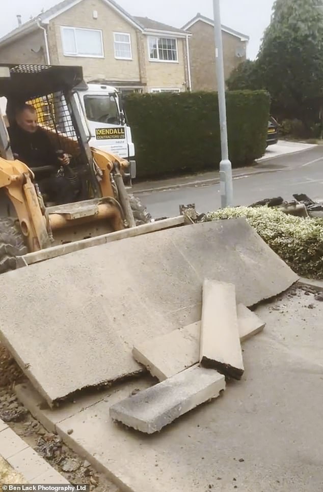 The footage appears to show a man with a chainsaw tearing into the newly-completed tarmac, set to music. A digger is then seen destroying parts of the driveway