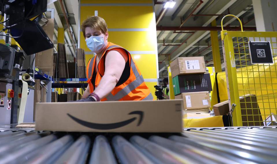 Amazon employee preparing a package for shipment.