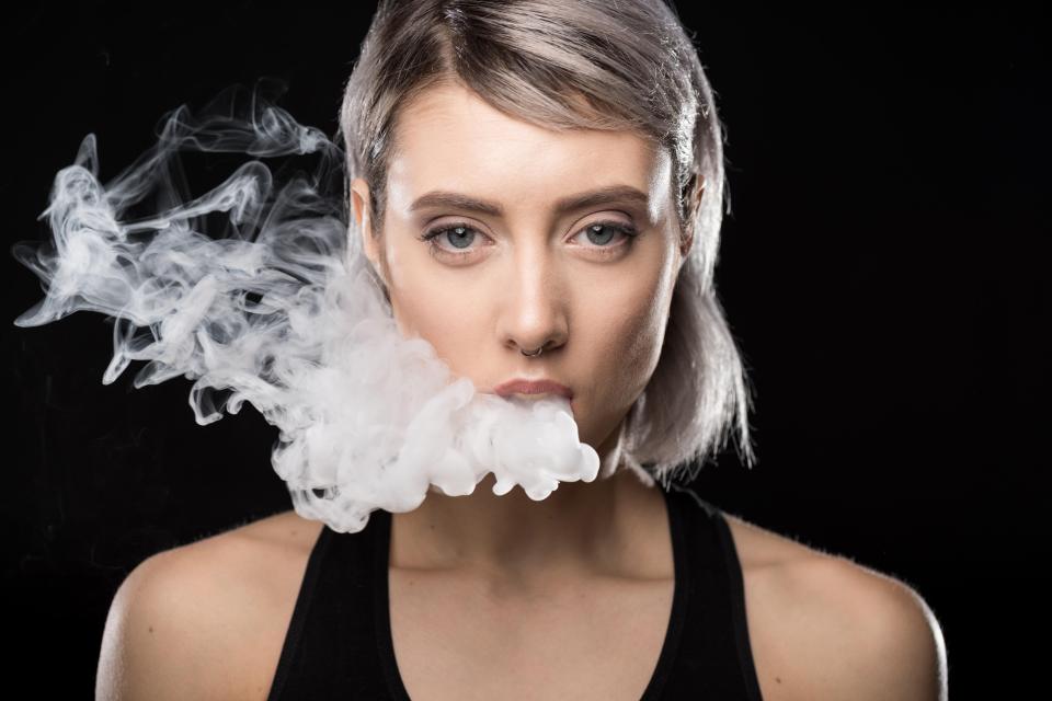 Young woman vaping.