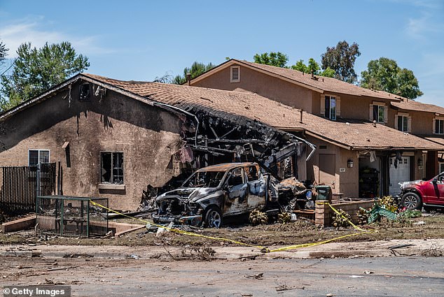 : A house is damaged after a small plane crashed into a neighborhood, setting homes and vehicles on fire on May 22, 2025