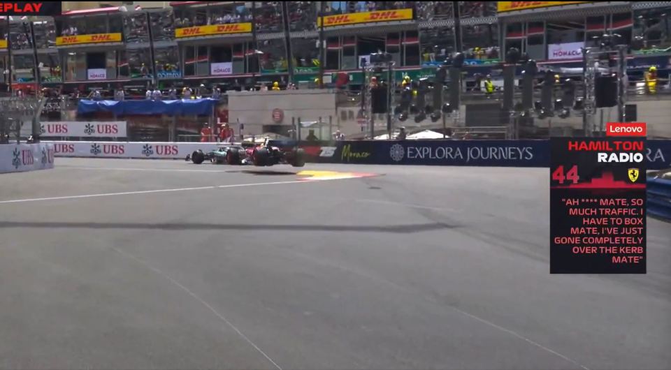 Replay of a Formula 1 race car going over a curb.
