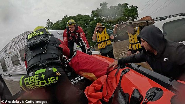 Fire and Rescue NSW crews moving house to house through waist-deep water to account for flood victims as the death count rises to five