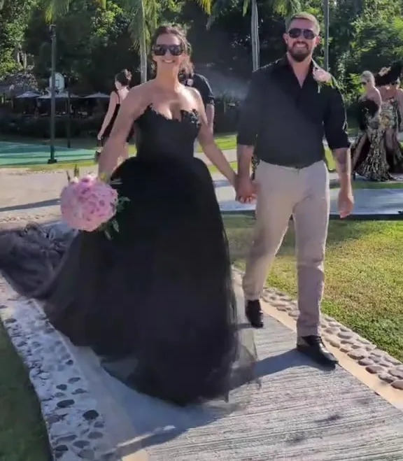 Bride and groom walking down a path after their wedding in Jamaica.