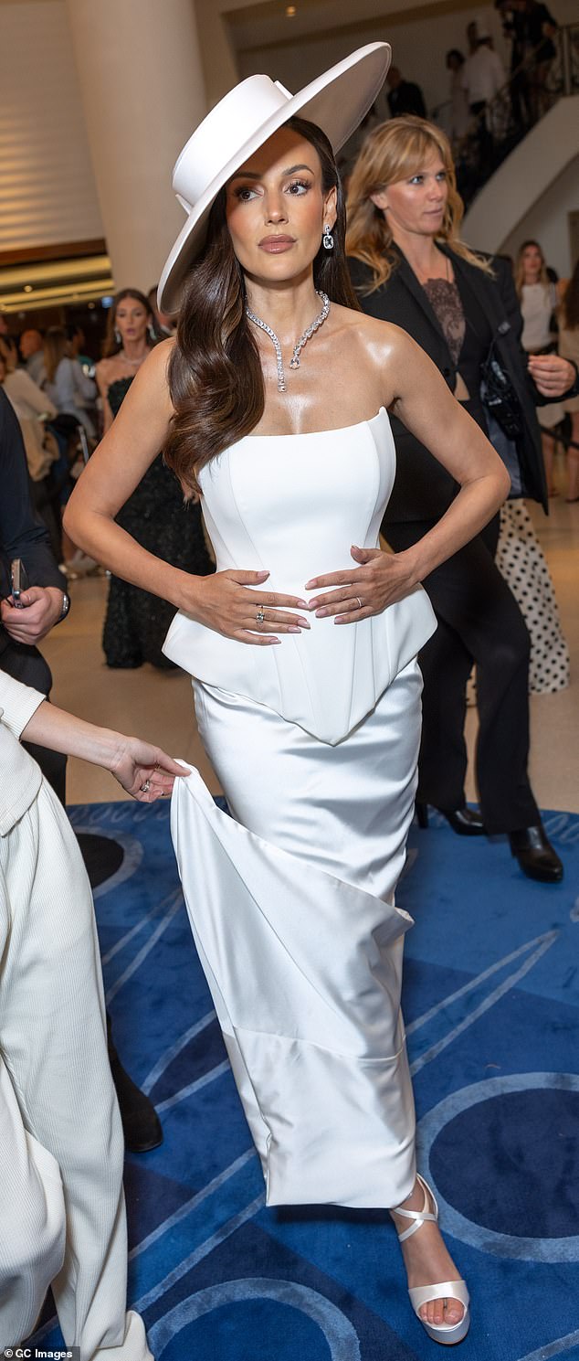 Michelle turned heads as she stepped out in a stunning white corseted strapless gown, which featured a peplum design and figure-hugging skirt