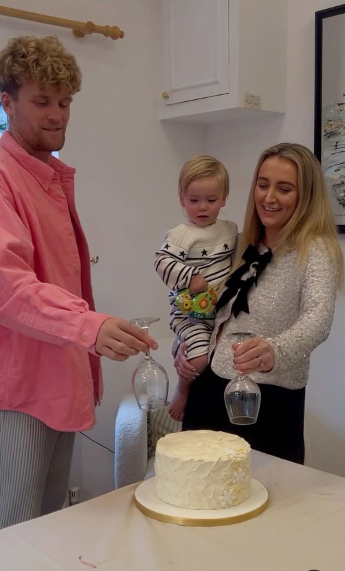 Family revealing baby's gender with a cake.