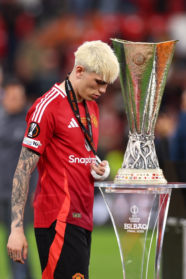 Alejandro Garnacho of Manchester United reacts near the UEFA Europa League trophy.