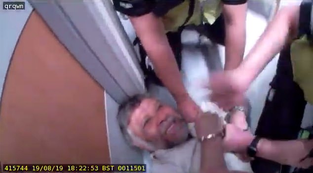Rashid is seen being detained by police in the hospital that cannot be named