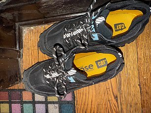Apair of women's size black CAT sneakers were outside the door, despite the FBI raiding the apartment 24 hours earlier