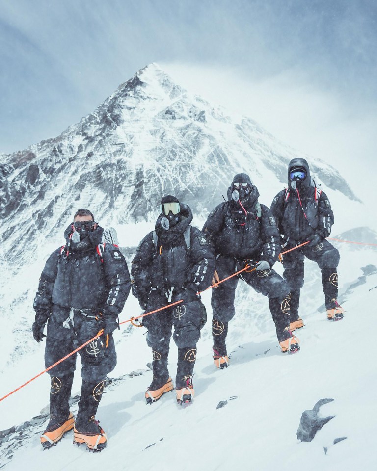 Four climbers ascending Mount Everest.