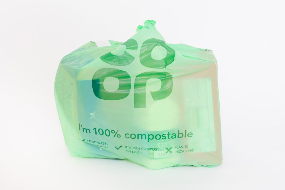 A light green compostable bag with the Co-op logo.