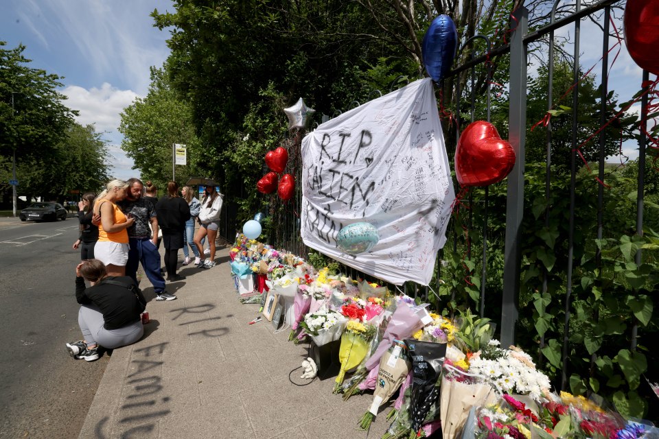 Floral tributes and messages at a memorial for two teenage boys.