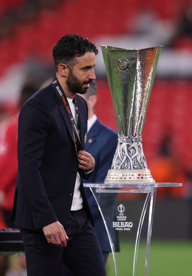 Ruben Amorim, manager of Manchester United, walks past the UEFA Europa League trophy.